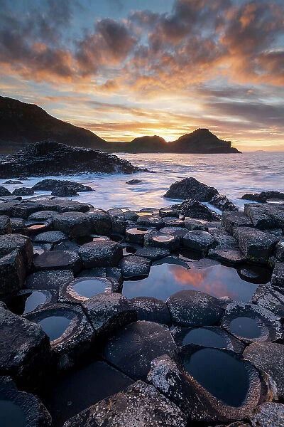 Sunset over the Giant's Causeway World Heritage Site on the Causeway Coast, Bushmills, County Antrim, Northern Ireland. Autumn (November) 2022