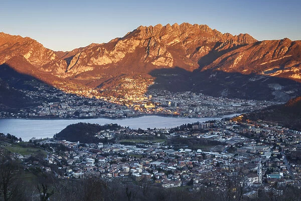 Sunset on Lecco and red mountains from the Plain of San Tomaso, lake Como, Lombardy