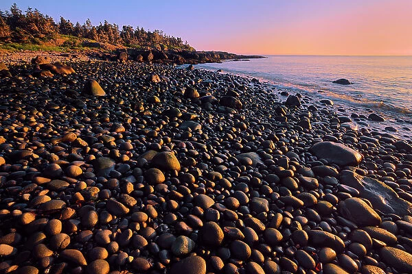 Sunset on a pebble beach at Flower's Cove