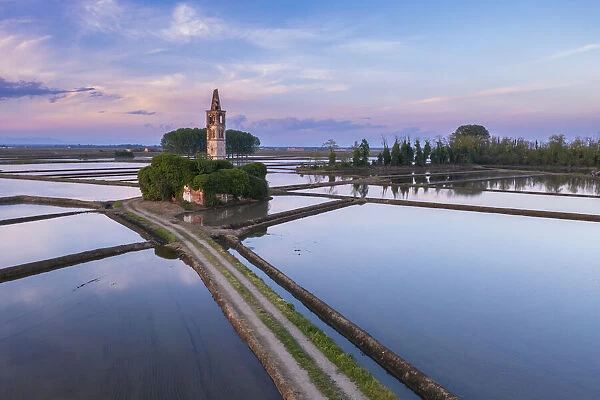 Sunset over the rice fields and abandoned church of Sant Antonio