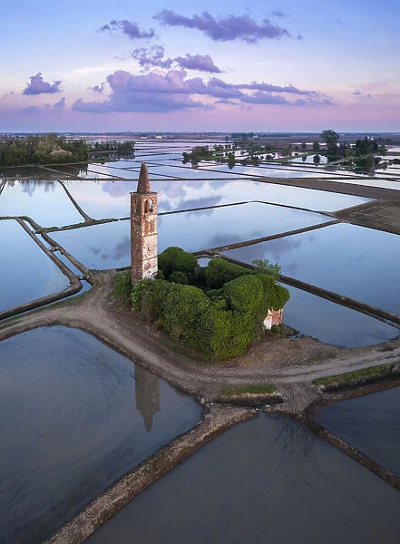 Sunset over the rice fields and abandoned church of Sant Antonio