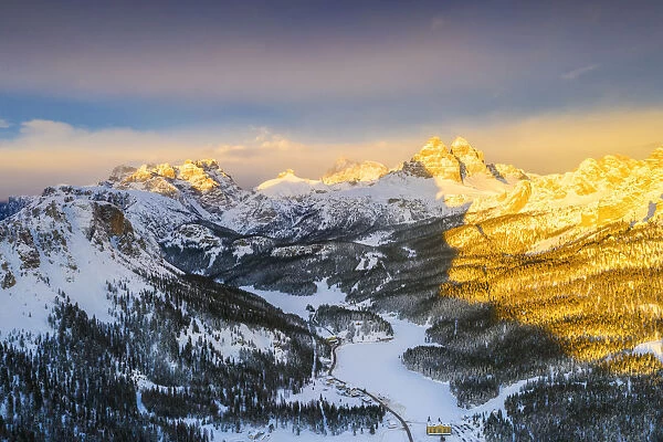 Sunset over Tre Cime di Lavaredo and Monte Piana covered with snow, aerial view, Misurina