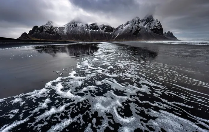 Framed Print : Surf from waves on black volcanic sand beach with Vestrahorn in the distance, Stokksnes, South Iceland