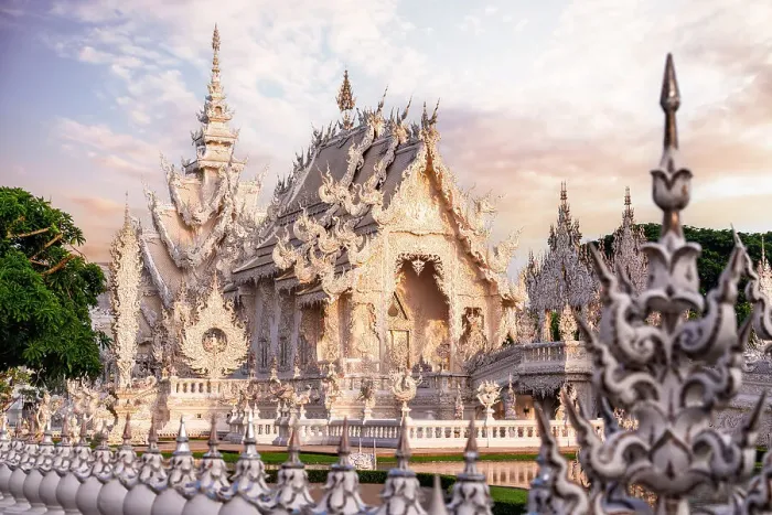 Framed Print : Surreal architecture and decorated fence at Wat Rong Khun (White Temple) at sunrise, Chiang Rai, Thailand Framed Print : Surreal architecture and decorated fence at Wat Rong Khun (White Temple) at sunrise, Chiang Rai, Thailand