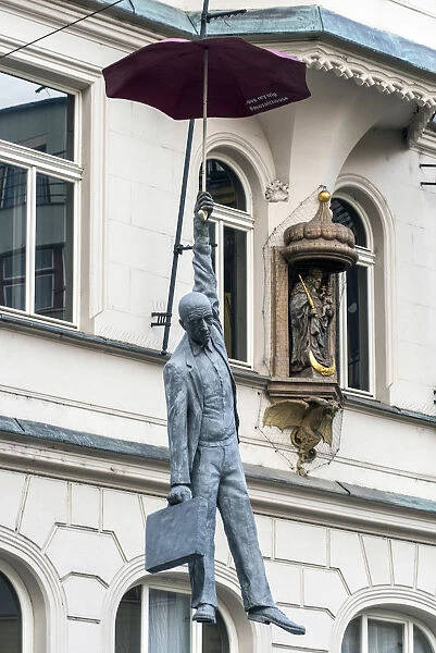 Suspended man with umbrella street sculpture, Prague, Bohemia, Czech Republic
