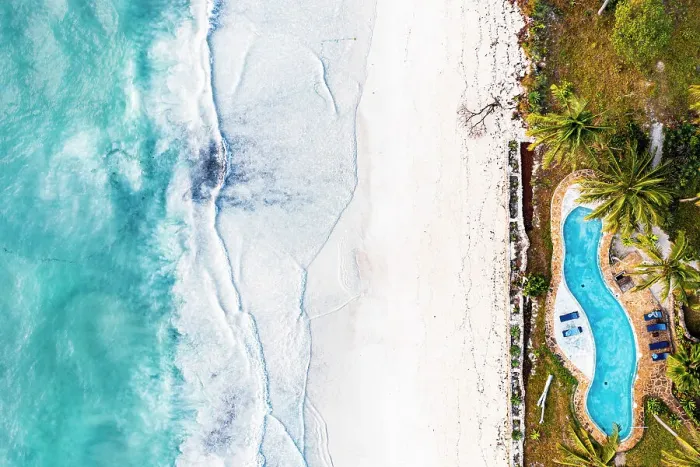 Framed Print : Swimming pool of a tourist resort on white coral beach washed by waves, overhead view, Zanzibar, Tanzania Framed Print : Swimming pool of a tourist resort on white coral beach washed by waves, overhead view, Zanzibar, Tanzania