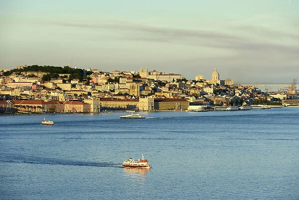The Tagus river (Tejo river) and the historic centre of Lisbon in the evening. Portugal