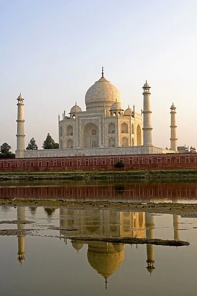 Taj Mahal at sunset with Yamuna River in foreground, Agra, India