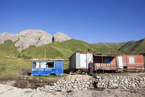 A Tajik woman stands outside her home on the Pamir Highway; Tajikistan