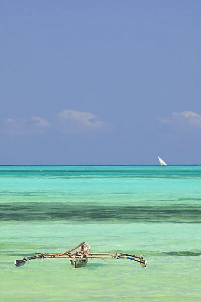 Tanzania, Zanzibar, Unguja, Jambiani. A traditional dhow moored near the shore