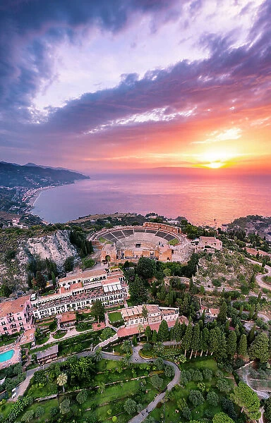 Taormina, Sicily. Aerial view of the Greek theater with the sun rising on the sea in the