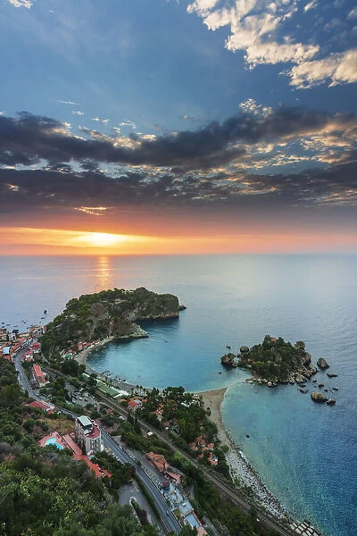 Taormina, Sicily. Elevated view of Isola Bella in Taormina with the sun rising