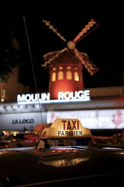 Taxi sign with Moulin Rouge in background, Paris, France