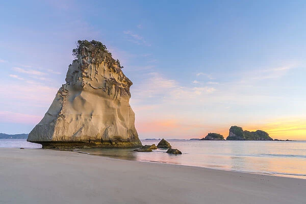 Te Hoho rock at Cathedral Cove at sunrise, with Poikeke and Motueka islands in the