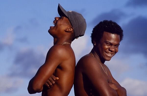 Two teenage boys laugh and joke in Sao Paulo sunshine