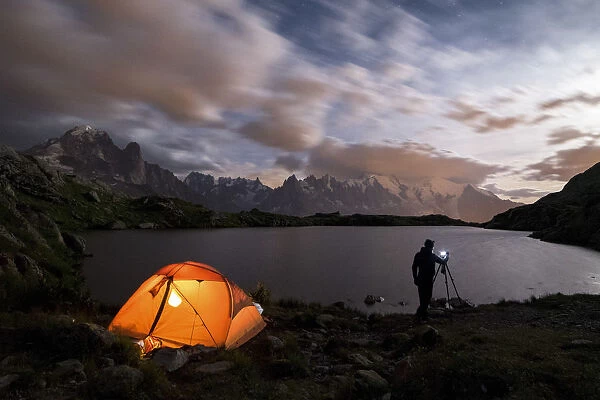 Tent and photographer in front of Mont Blanc from Lac de Chesery during summer night