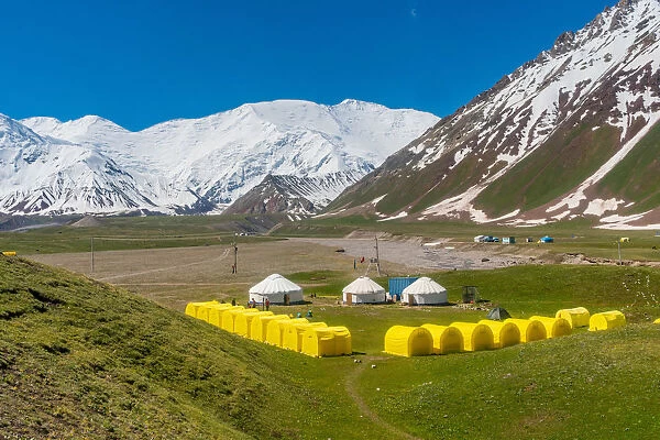 The tents of peak Lenin base camp with Lenin peak in the background