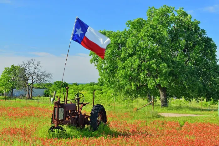 Framed Print : Texas flag on a 1935 John Deer tractor in a field of paintbrush, Burnet County, Texas, USA Framed Print : Texas flag on a 1935 John Deer tractor in a field of paintbrush, Burnet County, Texas, USA