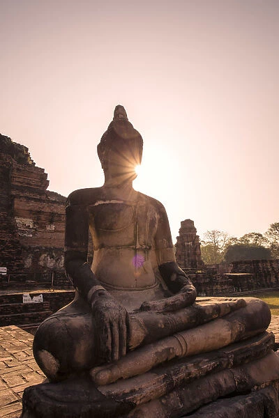 Thailand, Ayutthaya. Buddha statue at sunrise, Wat Mahathat, Ayutthaya historical park