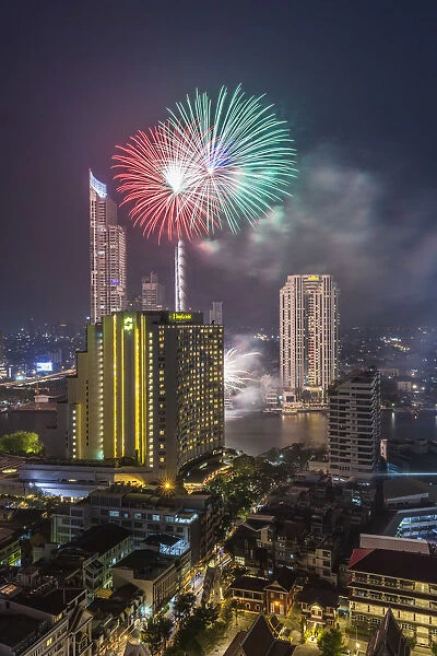 Thailand, Bangkok, Riverside Area, high angle skyline view with fireworks, dusk