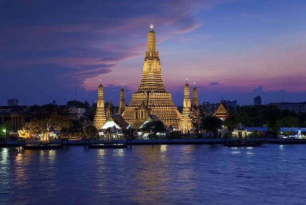 Thailand, Bangkok, Wat Arun, Temple Of The Dawn & Chao Phraya River illuminated at sunset