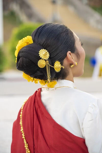 Thailand, Lampang, Wat Phrathat Lampang Luang, rear view of womans traditional costume