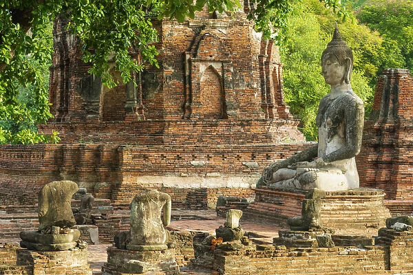 Thailand, Phra Nakhon Si Ayutthaya, Ayutthaya, Wat Mahathat, Buddha amongst ancient ruins. UNESCO World Heritage site