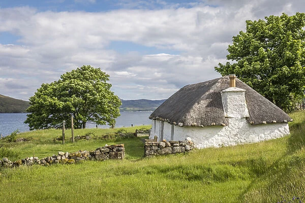 Thatched roof cottage on Loch Airnord at Luib, Isle of Skye, Highlands, Scotland