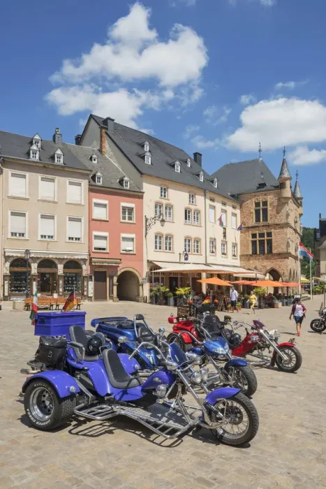 Framed Print : Three-wheeled motorbikes with the historic court house Denzelt at Echternach, Luxembourg Framed Print : Three-wheeled motorbikes with the historic court house Denzelt at Echternach, Luxembourg