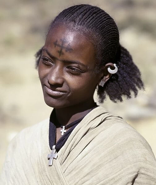 A Tigray woman has a cross of the Ethiopian Orthodox