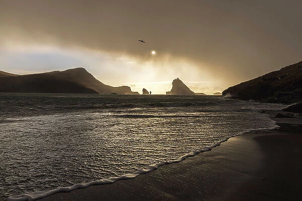 Tindholmur islet and Drangarnir sea stacks seen from the beach of Bour. Island of Vagar. Faroe Islands