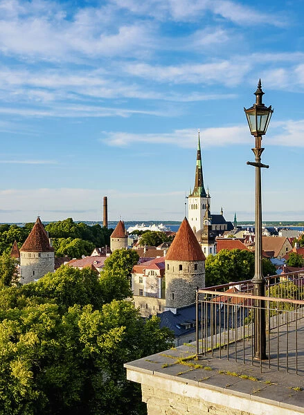 Toompea Hill Lookout Point, view over the Old Town towards St Olafs Church at sunset, Tallinn, Estonia