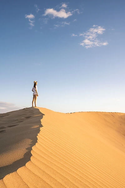 Tourist admiring the view on sand dunes. Maspalomas, Las Palmas, Gran Canaria