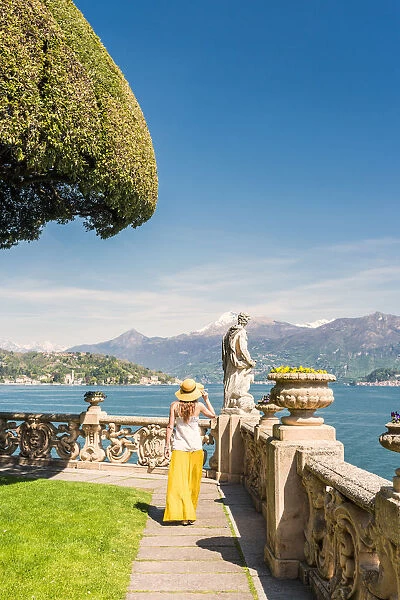 Tourist admiring Villa del Balbianello gardens on Punta di Lavedo, Lenno, Como province