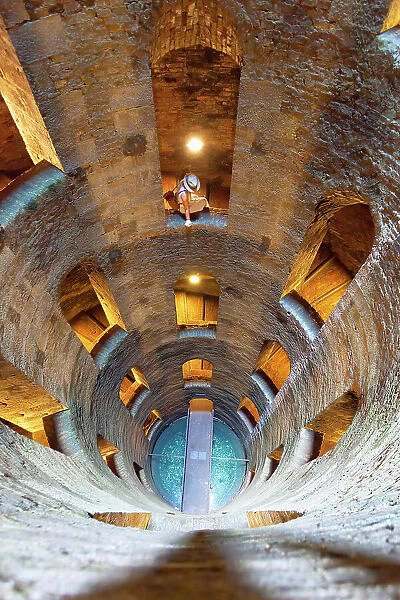 A tourist in St. Patrick's Well (Pozzo di San Patrizio), a historic well in Orvieto, Terni province, Umbria region, Italy. (MR)