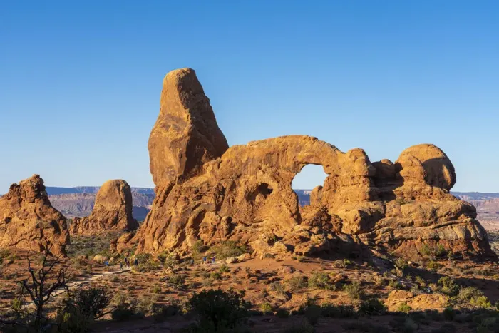Framed Print : Tourists approaching Turret Arch against clear sky on sunny day, Arches National Park