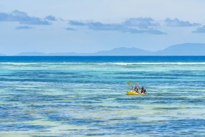 Framed Print : Tourists canoeing in la Digue, Seychelles, Africa Framed Print : Tourists canoeing in la Digue, Seychelles, Africa