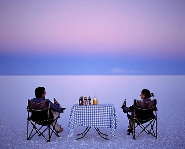 Tourists enjoy sundowners while looking out across