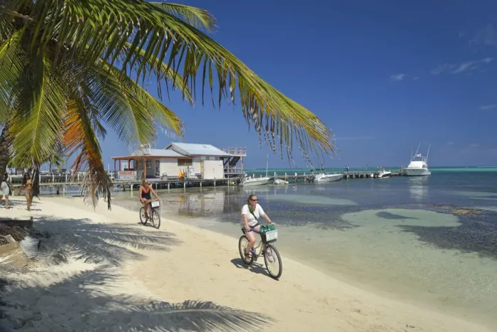 Framed Print : Tourists enjoying a bike ride along the beach at San Pedro, Ambergris Caye, Caribbean