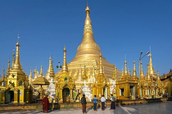 Tourists at gilded Shwedagon Pagoda against clear sky, Yangon, Yangon Region, Myanmar