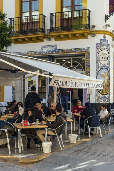 Framed Print : Tourists seated at tables outside a tapas bar in Seville, Andalusia, Spain Framed Print : Tourists seated at tables outside a tapas bar in Seville, Andalusia, Spain