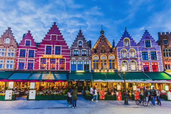 Framed Print : Tourists walking in Market Square in Bruges by night, Belgium Framed Print : Tourists walking in Market Square in Bruges by night, Belgium