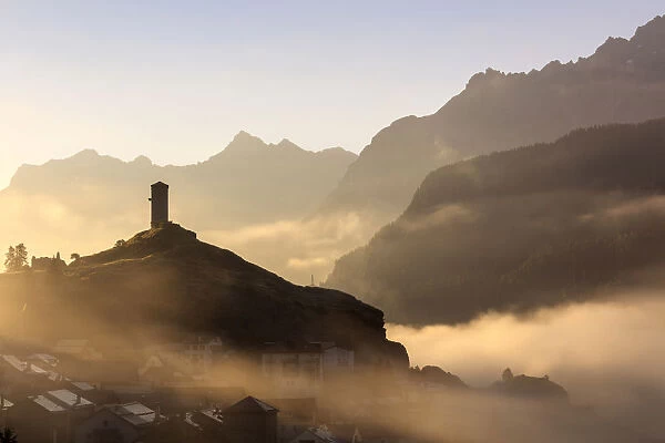 Tower of Steinsberg Castle shrouded by mist, Ardez, canton of GraubAonden, district