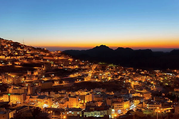 The town of Wadi Musa illuminated at twilight, Ma'an Governorate, Jordan, Middle East. It is the nearest town to the Nabatean archaeological site of Petra