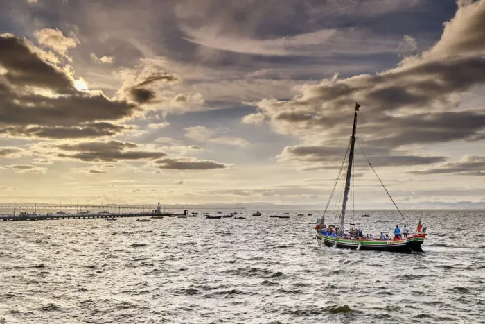 Framed Print : Traditional boat (Bote Leao) in the Tagus river. Lisbon is in front