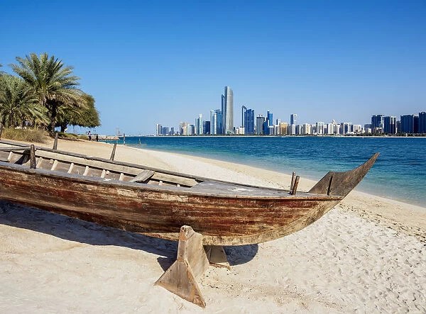 Traditional boat in the Heritage Village with city skyline in the background, Abu Dhabi