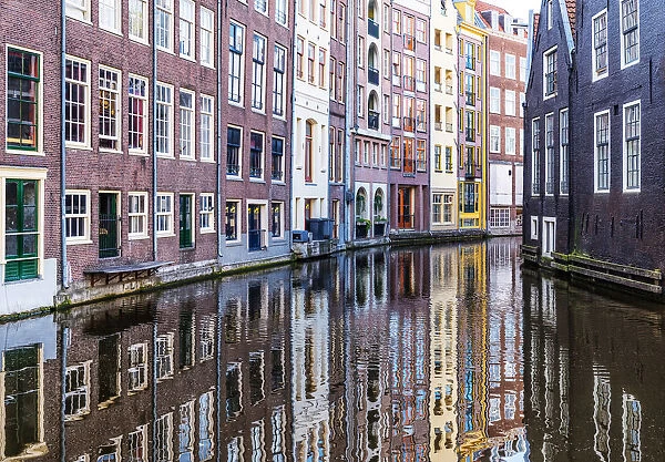 Traditional buildings reflected in the canal, Amsterdam, the Netherlands