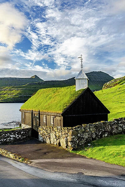 Traditional church with grass roof overlooking the fjord, Funningur, Eysturoy Island, Faroe Islands