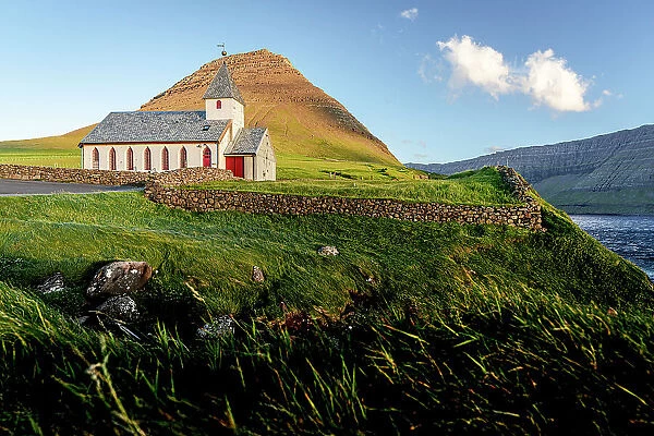 Traditional church of Vidareidi overlooking the ocean at sunset, Vidoy Island, Faroe Islands