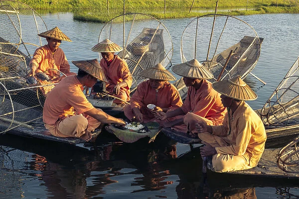 Traditional fishermen on Lake Inle having a supper on boats together, Lake Inle